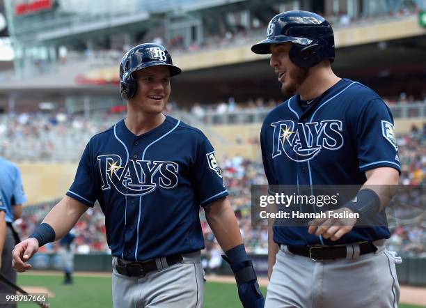 Jake Bauers and C.J. Cron of the Tampa Bay Rays celebrate scoring against the Minnesota Twins during the seventh inning of the game on July 14, 2018...