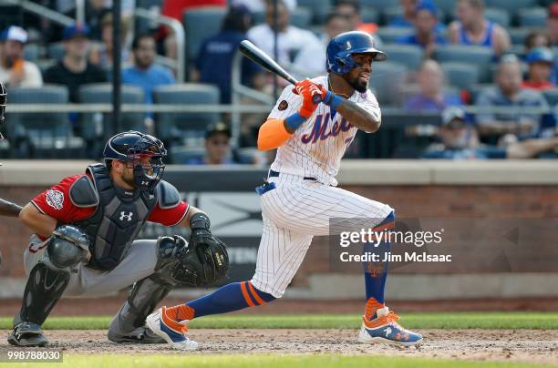 Jose Reyes of the New York Mets follows through on a fifth inning run scoring single against the Washington Nationals at Citi Field on July 14, 2018...