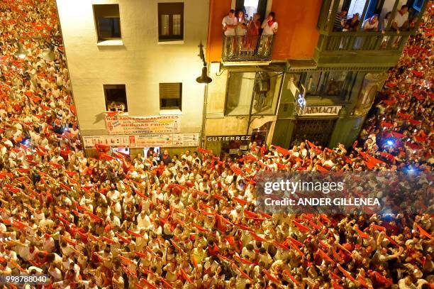 Revellers raise red scarves and candles as they sing the song 'Pobre de Mi', marking the end of the San Fermin festival in Pamplona, northern Spain...