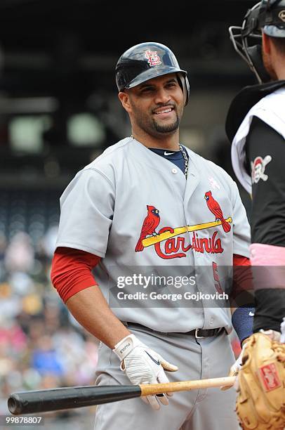 First baseman Albert Pujols of the St. Louis Cardinals smiles as he looks at catcher Ryan Doumit of the Pittsburgh Pirates after he was intentionally...