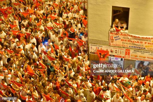 Revellers raise red scarves and candles as they sing the song 'Pobre de Mi', marking the end of the San Fermin festival in Pamplona, northern Spain...