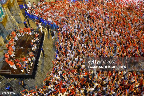 Revellers raise red scarves and candles as they sing the song 'Pobre de Mi', marking the end of the San Fermin festival in Pamplona, northern Spain...