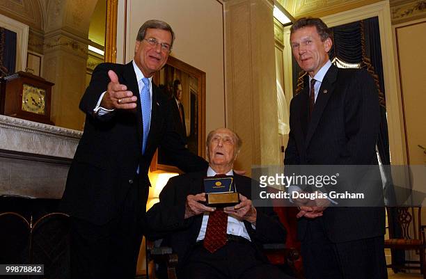 Strom Thurmond, R-S.C., recives a gift from Trent Lott, R-Miss., and Tom Daschle, D-S.D., during a press conference. The gift was a handless gavel...
