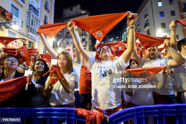 Revellers raise red scarves and candles as they sing the song 'Pobre de Mi', marking the end of the San Fermin festival in Pamplona, northern Spain...