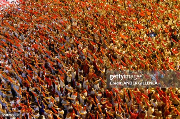 Revellers raise red scarves and candles as they sing the song 'Pobre de Mi', marking the end of the San Fermin festival in Pamplona, northern Spain...