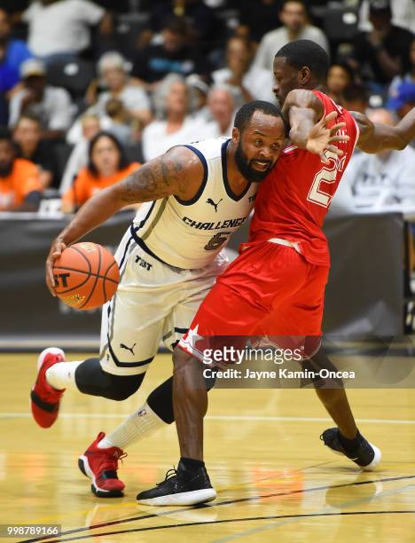 Red Brooks of the Fort Hood Wounded Warriors guards Jerry Smith of Team Challenge ALS as he drives to the basket during the game at Eagle's Nest...