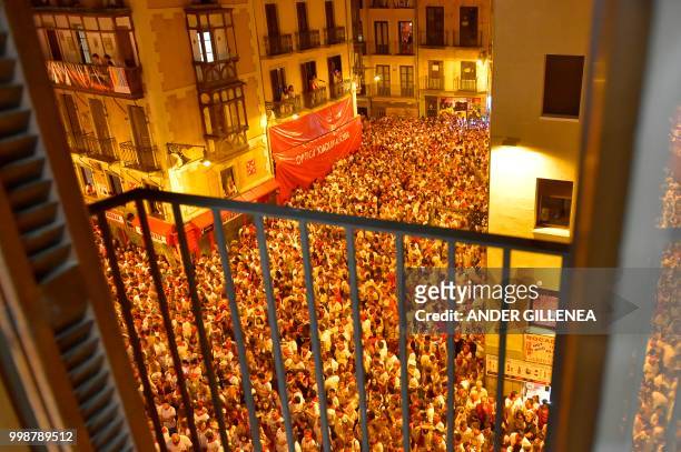 Revellers raise red scarves and candles as they sing the song 'Pobre de Mi', marking the end of the San Fermin festival in Pamplona, northern Spain...