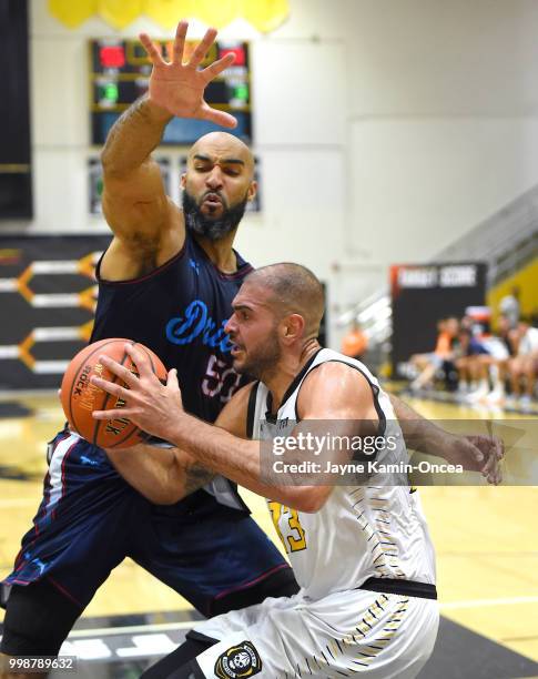 Liam McMorrow of Eberlein Drive guards Carl Baptiste of the Broad St. Brawlers as he drives to the basket in the game at Eagle's Nest Arena on July...