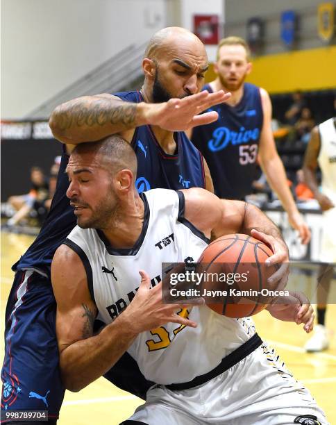 Liam McMorrow of Eberlein Drive guards Carl Baptiste of the Broad St. Brawlers as he drives to the basket in the game at Eagle's Nest Arena on July...