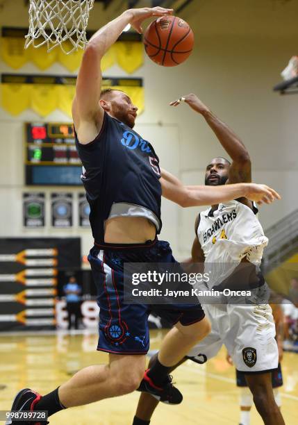 Alex Kirk of Eberlein Drive blocks a shot by Justin Edwards of the Broad St. Brawlers in the game at Eagle's Nest Arena on July 14, 2018 in Los...