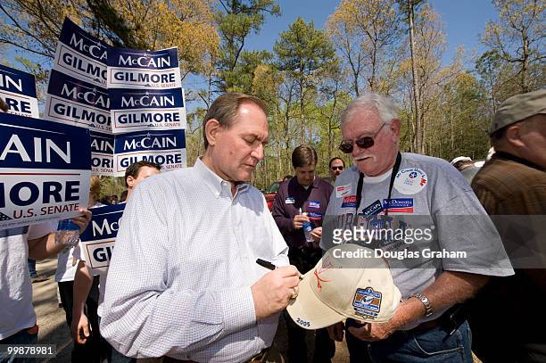 Former Gov. Jim Gilmore, R-Va., autographs a suporter's hat at the Wakefield Shad Planking, April 16, 2008 in Wakefield, Virginia.