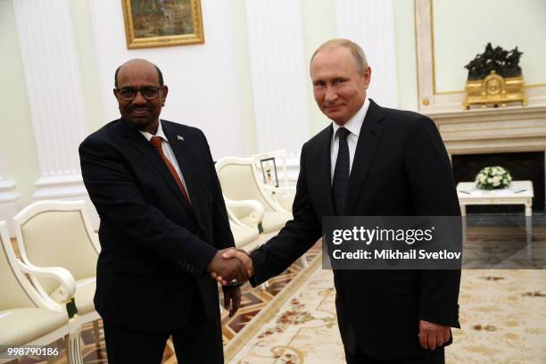 Russian President Vladimir Putin greets Sudanese President Omar al-Bashir during their talks at the Kremlin, in Moscow, Russia, July 2018. Sudanese...