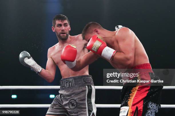 Rocky Fielding of Great Britain exchanges punches with Tyron Zeuge of Germany during their WBA Super Middleweight World Championship title fightat...