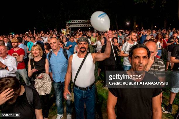 People celebrate the invitation to join NATO at an event in Skopje On July 14, 2018. - Thousands of people have gathered in 15 cities in Macedonia to...