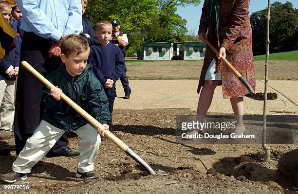 Joseph Lovins, age 5, helps out during a ceremony in which a six foot sapling clone of a white ash grown by George Washington circa 1785 was planted...