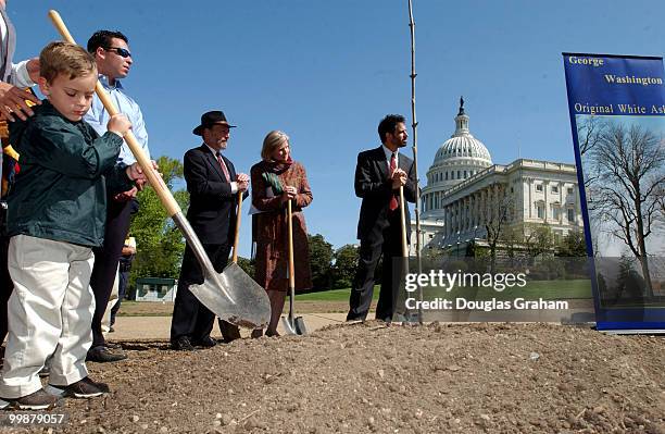 Joseph Lovins, age 5, helps out during a ceremony in which a six foot sapling clone of a white ash grown by George Washington circa 1785 was planted...