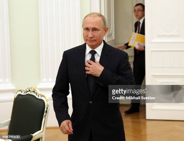 Russian President Vladimir Putin enters the hall as his Protocol Chief Vladislav Kitaev looks on during Russian-Sudanese talks at the Kremlin, in...