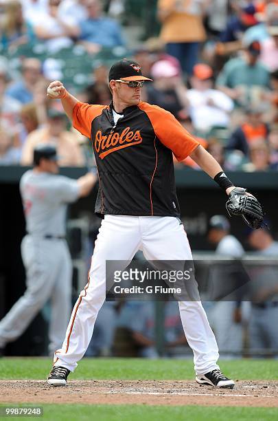 Matt Wieters of the Baltimore Orioles warms up the pitcher between innings of the game against the Cleveland Indians at Camden Yards on May 16, 2010...