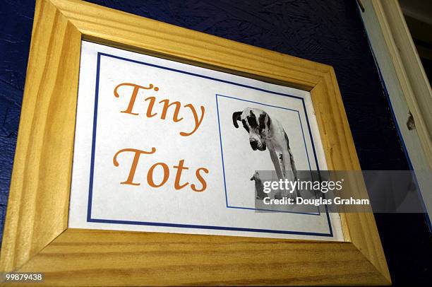 Sign for small breeds room at Wag Time reads tiny tots room.