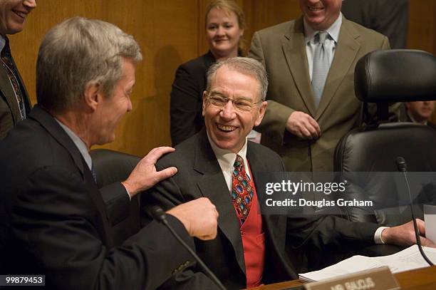 The new Chairman Max Baucus, D-MT., of the Senate Finance Committee talks with Chairman Charles Grassley, R-IA., before the start of the Full...