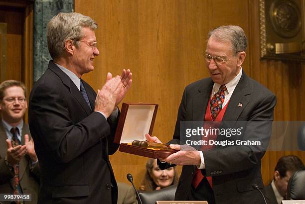 The new Chairman Max Baucus, D-MT., of the Senate Finance Committee gives the out going Chairman Charles Grassley, R-IA., a gavel before the start of...