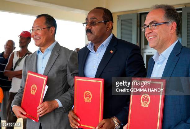 Antigua & Barbuda's Prime Minister Gaston Browne , China's Ambassador to the country Wang Xianmin and UN Resident Coordinator Steven O'Malley pose...