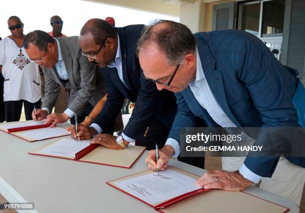 Antigua & Barbuda's Prime Minister Gaston Browne , China's Ambassador to the country Wang Xianmin and UN Resident Coordinator Steven O'Malley sign...
