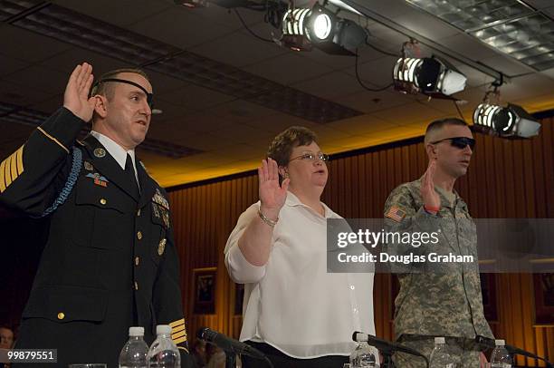 Staff Sgt. John Daniel Shannon and Annette McLeod, wife of Cpl. Wendell "Dell" McLeod and SPV Jeremy Duncan, U.S. Army are sworn in before the start...