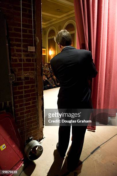 Former Governor of Virginia Mark Warner peeks out at the crowd before the start of a town hall meeting in downtown Blacksburg Virginia at the Lyric...