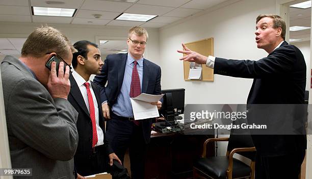 Communications Director Kevin Hall, ??? ,??? talk with their boss Mark Warner, D-VA., during their first day in the U.S. Senate on January 6, 2009.