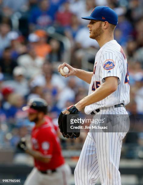 Zack Wheeler of the New York Mets looks on from the mound after surrendering an eighth inning two run home run against Matt Adams of the Washington...