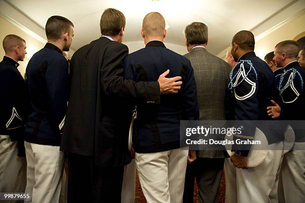 Former Governor of Virginia Mark Warner gets his picture taken with the Virginia Tech "Keydets" after a town hall meeting in downtown Blacksburg...