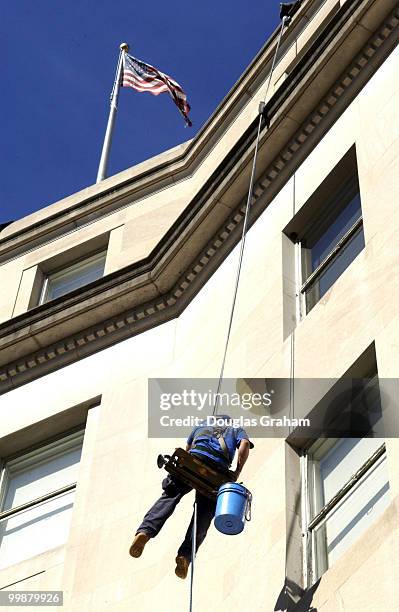 Window Washer Oscar Reyes hangs high above 51 Louisiana Ave. As he cleans the windows of the Acacia Life Insurance Building. Acacia Life Insurance...