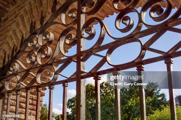 wall gate with ironwork at alcazaba - alcazaba of málaga stock pictures, royalty-free photos & images