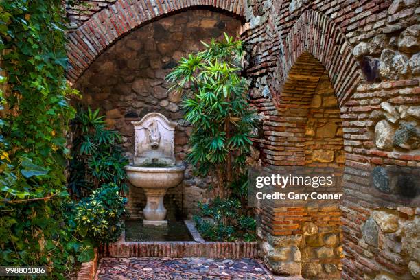 wall gate and fountain at alcazaba - alcazaba of málaga stock pictures, royalty-free photos & images