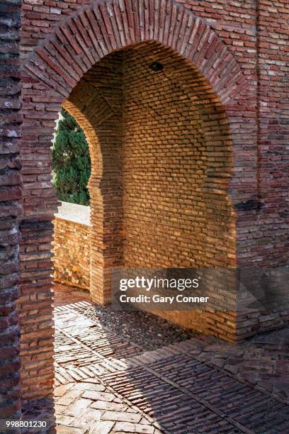 wall gate at alcazaba - alcazaba of málaga stock pictures, royalty-free photos & images