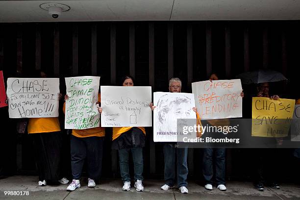 Demonstrators with the Neighborhood Assistance Corporation of America protest outside One Chase Plaza during the annual shareholders meeting of...