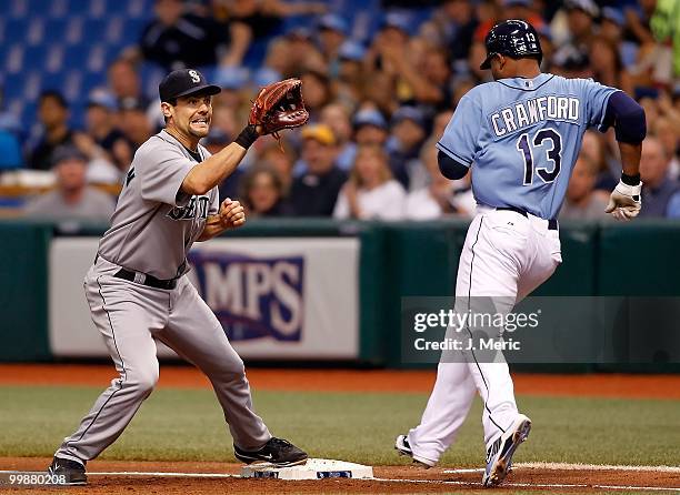 Outfielder Carl Crawford of the Tampa Bay Rays beats the throw to first as Casey Kotchman of the Seattle Mariners awaits the ball during the game at...