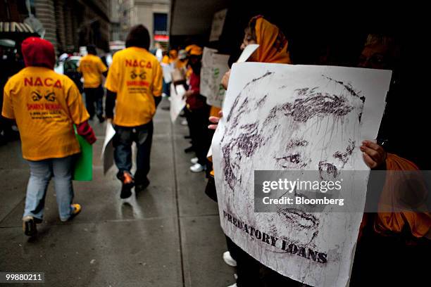 Demonstrators with the Neighborhood Assistance Corporation of America protest outside One Chase Plaza during the annual shareholders meeting of...