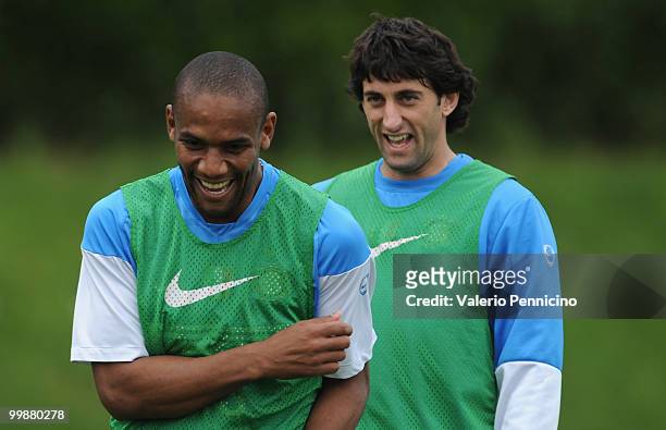 Douglas Santos Maicon and Diego Milito of FC Internazionale Milano attend an FC Internazionale Milano training session during a media open day on May...