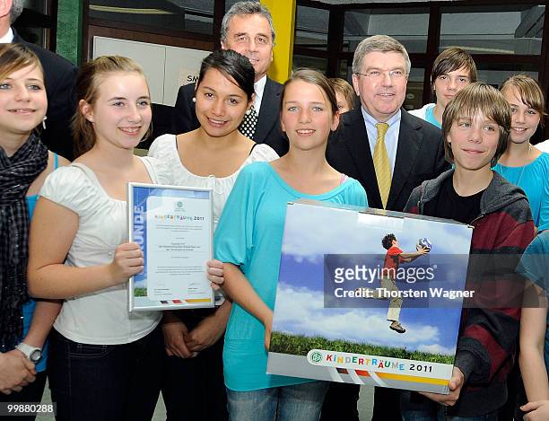 Thomas Bach , head of German Olympic Sport Association poses with children during the Children's dreams 2011 awards ceremony at the Riemenschneider...