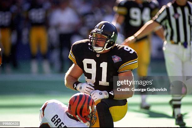 Linebacker Kevin Greene of the Pittsburgh Steelers looks up after tackling running back Harold Green of the Cincinnati Bengals during a game at Three...