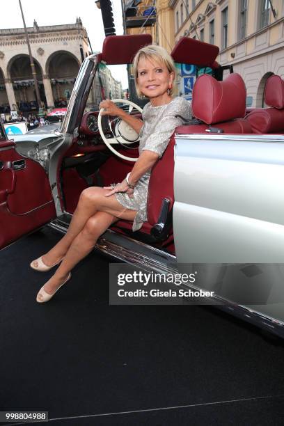 Uschi Glas sits in a Mercedes oldtimer car during the Mercedes-Benz reception at 'Klassik am Odeonsplatz' on July 14, 2018 in Munich, Germany.