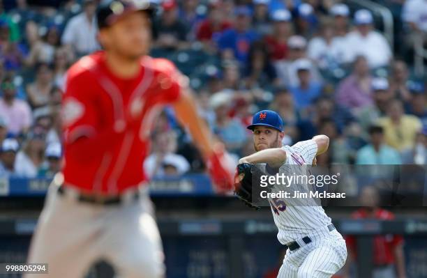 Zack Wheeler of the New York Mets throws out Trea Turner of the Washington Nationals after a bunt attempt in the fifth inning at Citi Field on July...