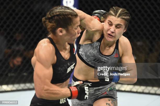 Jennifer Maia of Brazil punches Liz Carmouche in their women's flyweight fight during the UFC Fight Night event inside CenturyLink Arena on July 14,...