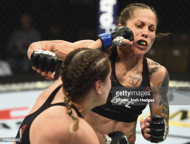 Jennifer Maia of Brazil punches Liz Carmouche in their women's flyweight fight during the UFC Fight Night event inside CenturyLink Arena on July 14,...
