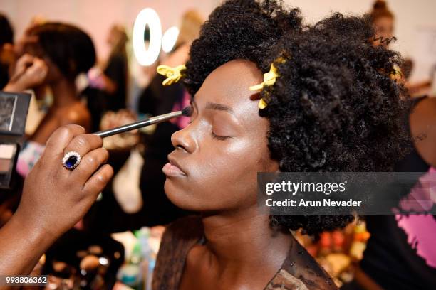 Model prepares backstage at Miami Swim Week powered by Art Hearts Fashion Swim/Resort 2018/19 at Faena Forum on July 14, 2018 in Miami Beach, Florida.