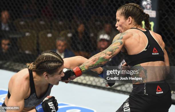Liz Carmouche punches Jennifer Maia of Brazil in their women's flyweight fight during the UFC Fight Night event inside CenturyLink Arena on July 14,...
