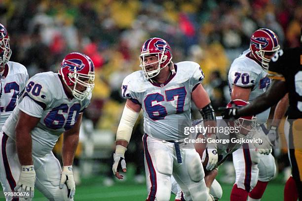 Center Kent Hull of the Buffalo Bills turns to guard Jerry Ostroski during a game against the Pittsburgh Steelers at Three Rivers Stadium on...