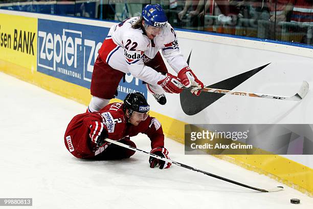 Kris Russell of Canada is challenged by Lukas Kaspar of Czech Republic during the IIHF World Championship group F qualification round match between...